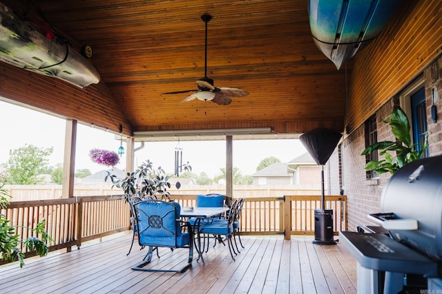 sunroom / solarium with outdoor dining space, a ceiling fan, and lofted ceiling