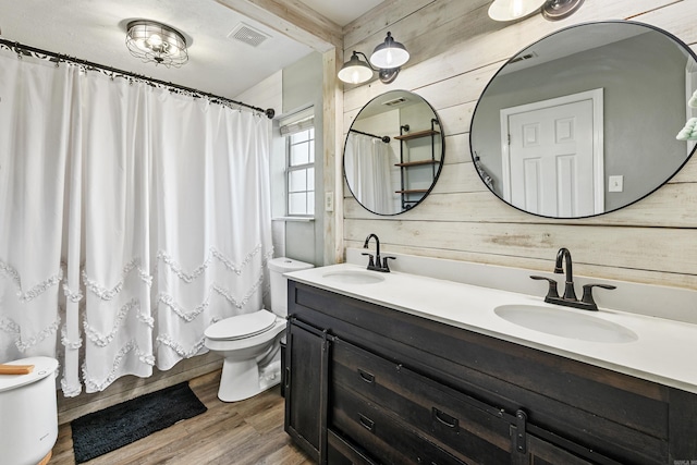 12 High Plains Dr, Cabot, AR 72023 - full bathroom featuring toilet, wood finished floors, double vanity, wooden walls, and curtained shower