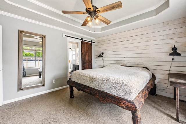 12 High Plains Dr, Cabot, AR 72023 - carpeted bedroom featuring a raised ceiling, wood walls, ornamental molding, a barn door, and a ceiling fan