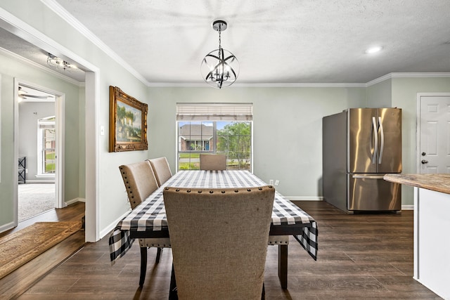 12 High Plains Dr, Cabot, AR 72023 - dining space with a chandelier, dark wood finished floors, baseboards, ornamental molding, and a textured ceiling