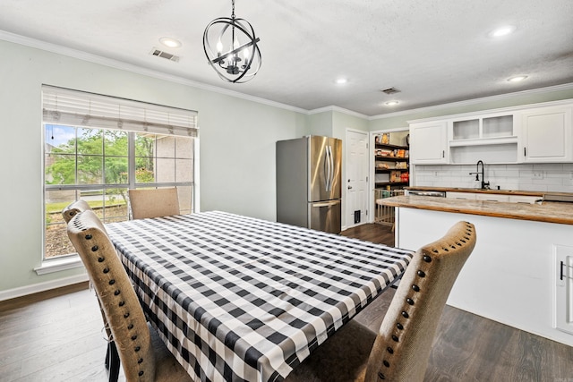 12 High Plains Dr, Cabot, AR 72023 - dining space with dark wood-style flooring, crown molding, recessed lighting, a chandelier, and baseboards