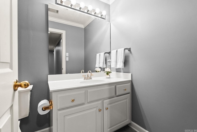 bathroom with crown molding, baseboards, and vanity