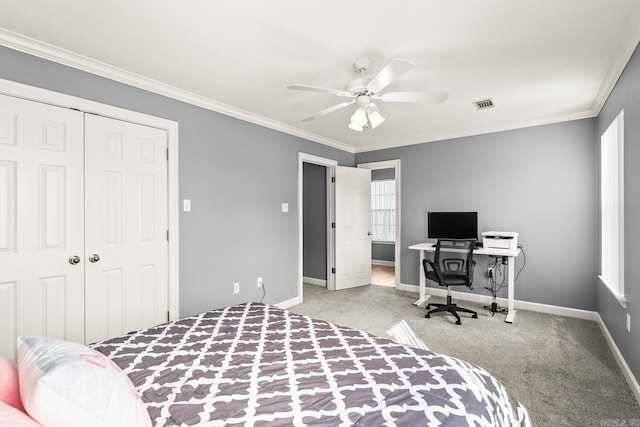 carpeted bedroom with a closet, baseboards, multiple windows, crown molding, and ceiling fan
