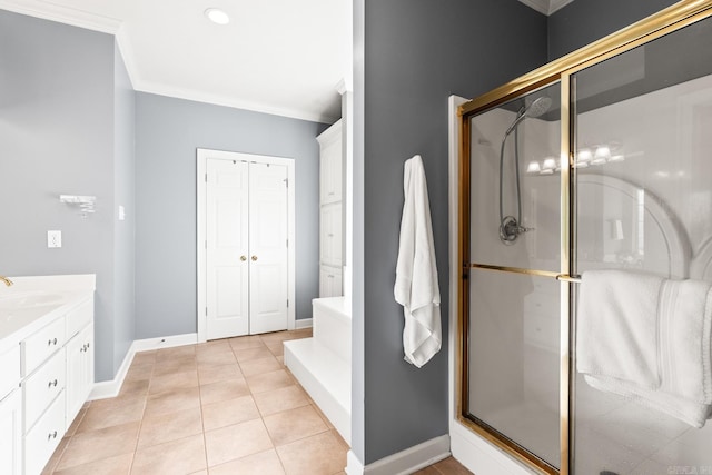 bathroom featuring a shower stall, crown molding, tile patterned flooring, baseboards, and vanity