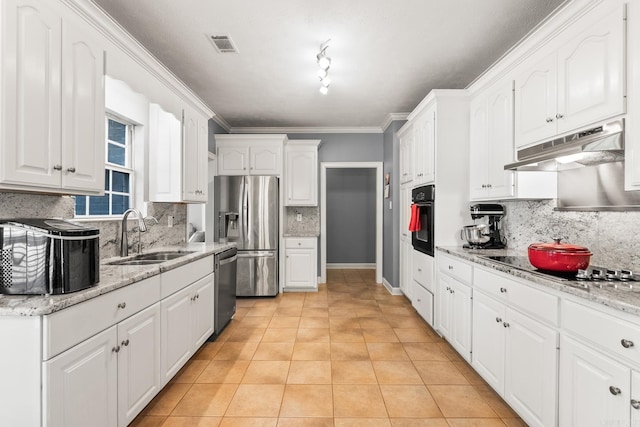 kitchen with a sink, under cabinet range hood, black appliances, backsplash, and white cabinets
