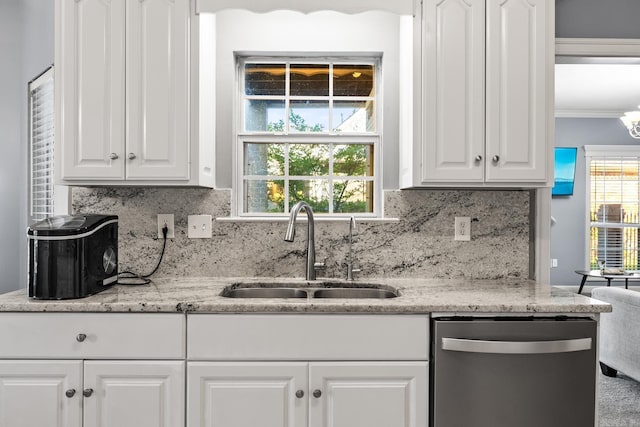kitchen with stainless steel dishwasher, a sink, white cabinets, backsplash, and ornamental molding