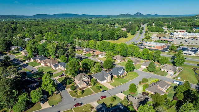view of property location with a mountainous background and a heavily wooded area