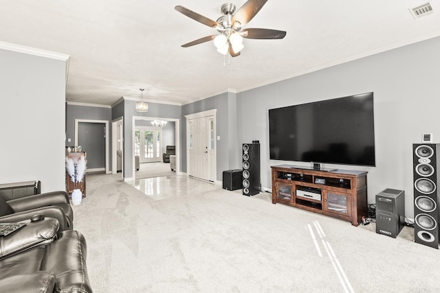 carpeted living area with ceiling fan, ornamental molding, baseboards, and a chandelier