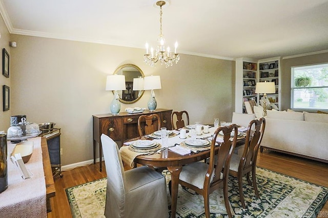 8113 Leatrice Dr, Little Rock, AR 72227 - dining area featuring a chandelier, ornamental molding, wood finished floors, and baseboards