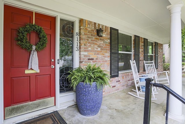8113 Leatrice Dr, Little Rock, AR 72227 - property entrance featuring a porch and brick siding
