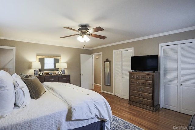 8113 Leatrice Dr, Little Rock, AR 72227 - bedroom featuring multiple closets, ornamental molding, dark wood finished floors, and a ceiling fan