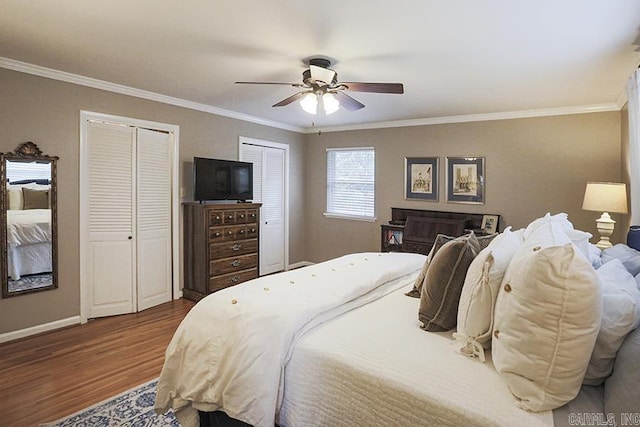 8113 Leatrice Dr, Little Rock, AR 72227 - bedroom featuring wood finished floors, two closets, ornamental molding, baseboards, and a ceiling fan