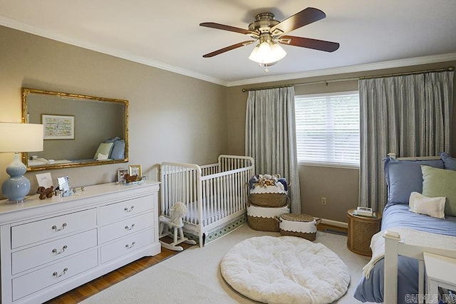 8113 Leatrice Dr, Little Rock, AR 72227 - bedroom with ornamental molding, ceiling fan, a crib, and wood finished floors