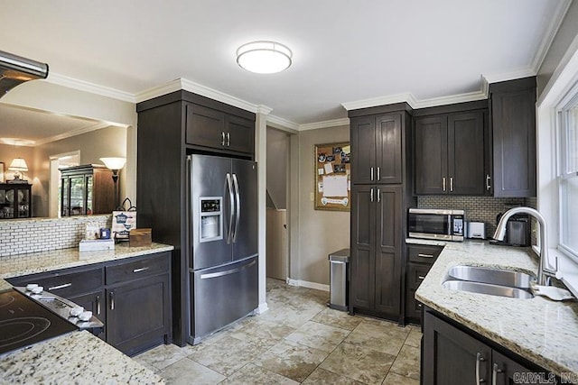 8113 Leatrice Dr, Little Rock, AR 72227 - kitchen featuring appliances with stainless steel finishes, a sink, baseboards, tasteful backsplash, and light stone countertops