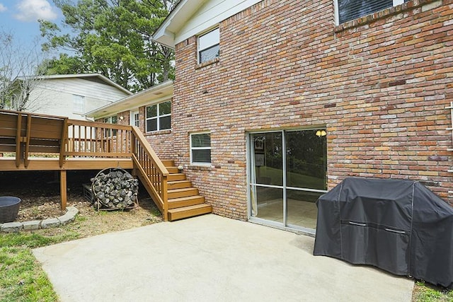 8113 Leatrice Dr, Little Rock, AR 72227 - rear view of property featuring stairway, a wooden deck, a patio area, and brick siding