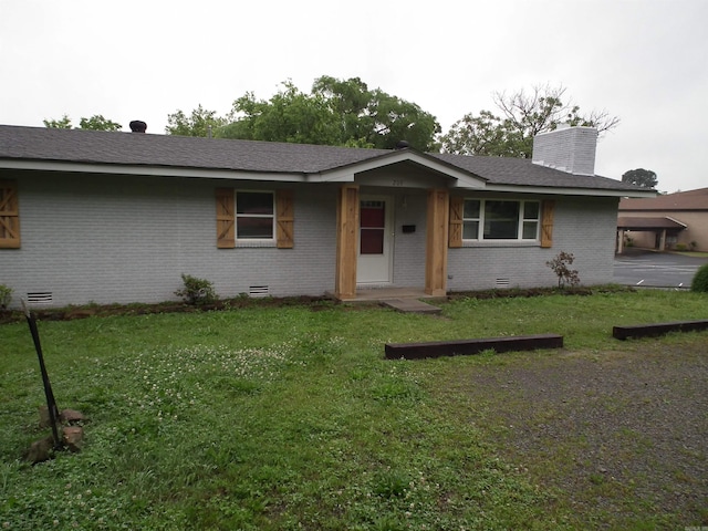 ranch-style home with crawl space, brick siding, and a front yard