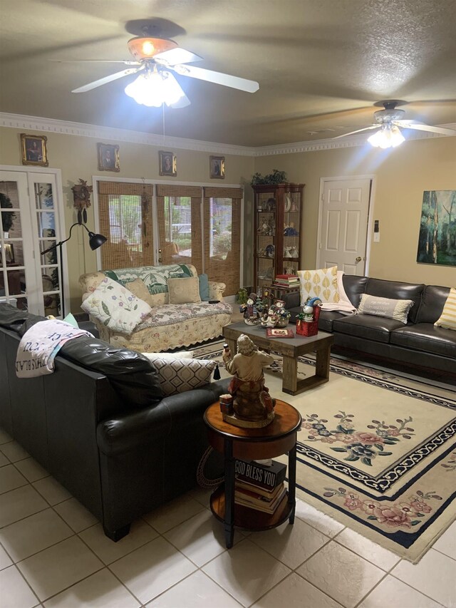 living area with ceiling fan, light tile patterned floors, and crown molding