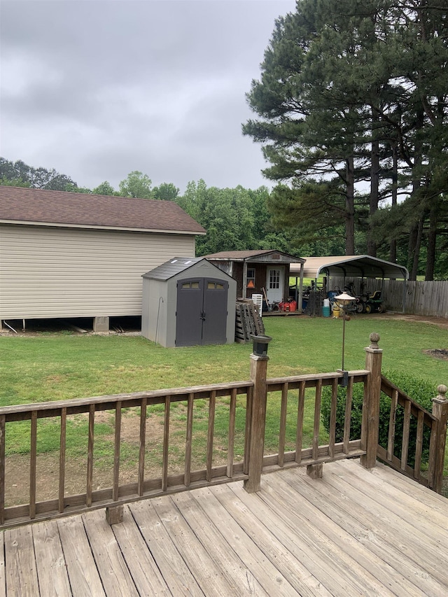 deck with a storage shed, a yard, an outdoor structure, and a detached carport