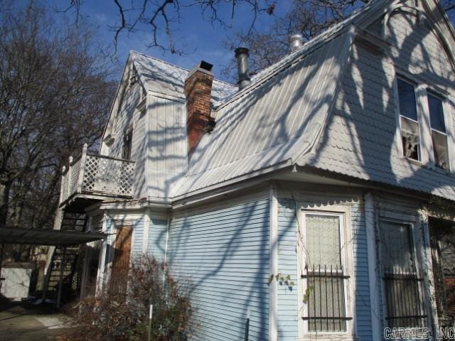 1612 W 23rd St, Little Rock, AR 72206 - view of side of property featuring a gambrel roof, a chimney, and a balcony