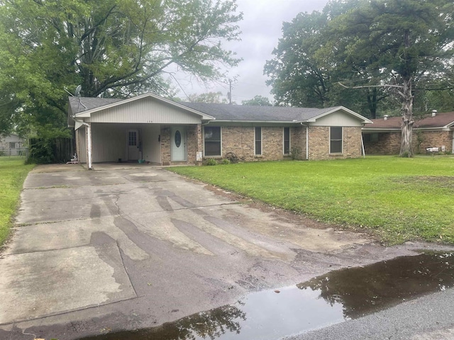 ranch-style house with a front lawn, concrete driveway, an attached carport, and brick siding