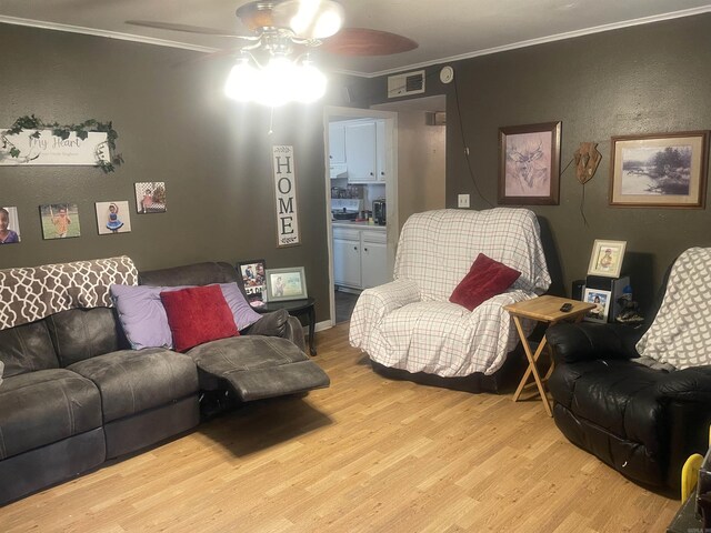 living room featuring a ceiling fan, light wood finished floors, and ornamental molding