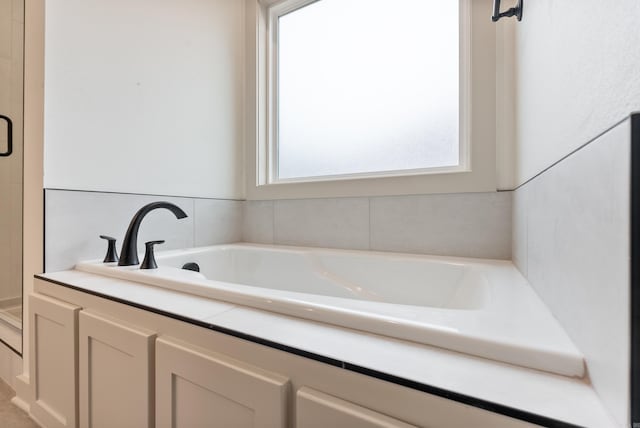 full bath with a garden tub