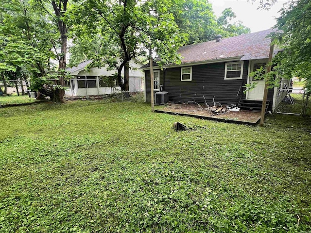 view of yard featuring central AC unit and entry steps