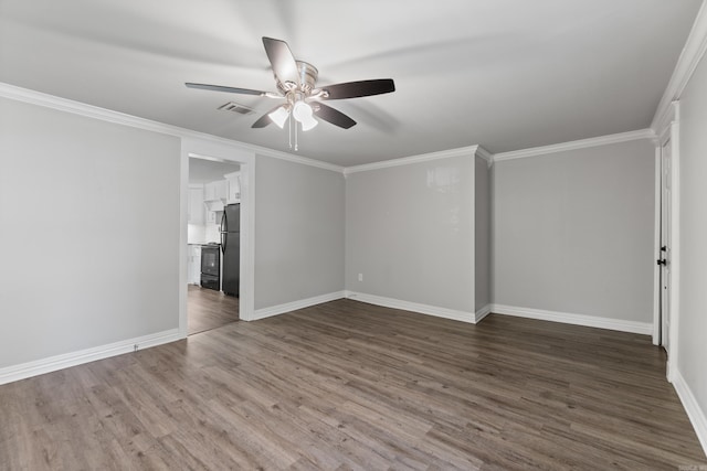 unfurnished bedroom featuring freestanding refrigerator, dark wood finished floors, crown molding, baseboards, and a ceiling fan