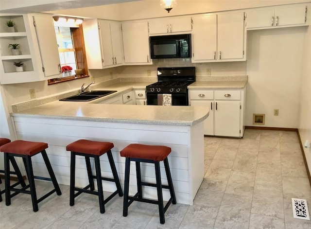 240 Round Up Ln, Mountain Home, AR 72653 - kitchen featuring black appliances, a sink, a peninsula, open shelves, and light countertops