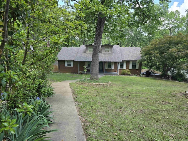 240 Round Up Ln, Mountain Home, AR 72653 - view of front facade featuring a front yard, roof with shingles, and brick siding