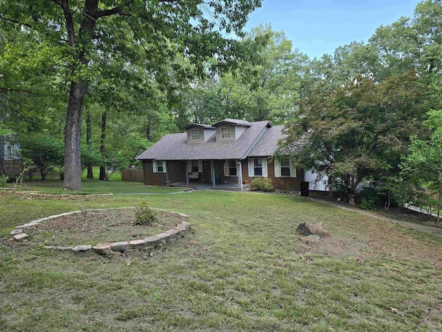 240 Round Up Ln, Mountain Home, AR 72653 - view of front of home with a front yard, a shingled roof, a porch, and brick siding