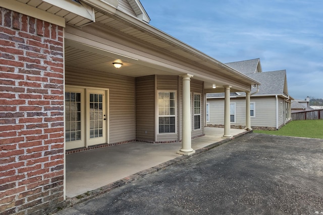 406 Parliament St, Little Rock, AR 72211 - entrance to property with roof with shingles, a patio, and brick siding