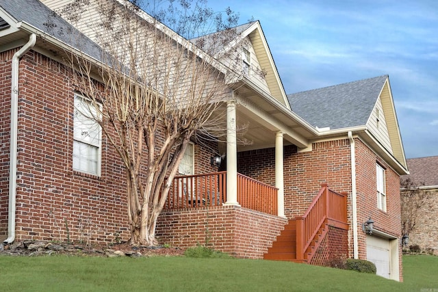 406 Parliament St, Little Rock, AR 72211 - view of side of home with brick siding, roof with shingles, covered porch, and a lawn