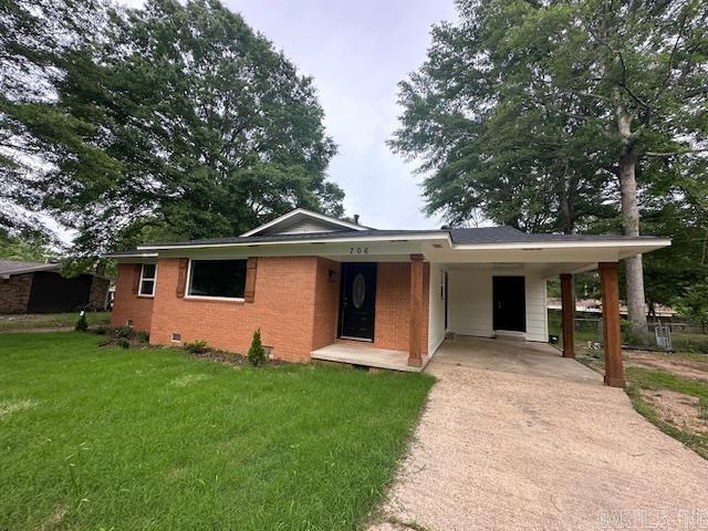 706 Scott St, Sheridan, AR 72150 - ranch-style house with concrete driveway, a front lawn, crawl space, a carport, and brick siding
