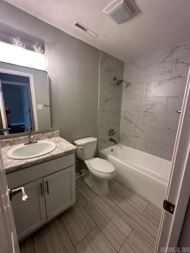 706 Scott St, Sheridan, AR 72150 - bathroom featuring a textured ceiling, vanity, toilet, and tub / shower combination