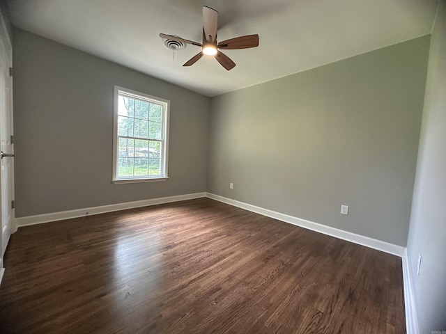 706 Scott St, Sheridan, AR 72150 - empty room with dark wood-style flooring, a ceiling fan, and baseboards