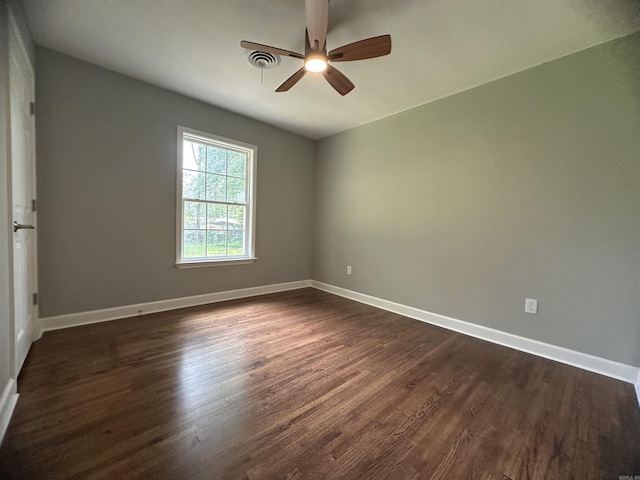 706 Scott St, Sheridan, AR 72150 - empty room with dark wood finished floors, a ceiling fan, and baseboards