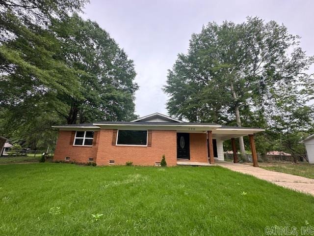 706 Scott St, Sheridan, AR 72150 - view of front of house featuring crawl space, concrete driveway, a front yard, a carport, and brick siding