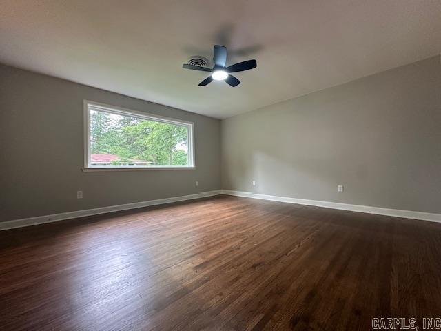 706 Scott St, Sheridan, AR 72150 - unfurnished room featuring dark wood finished floors, baseboards, and ceiling fan