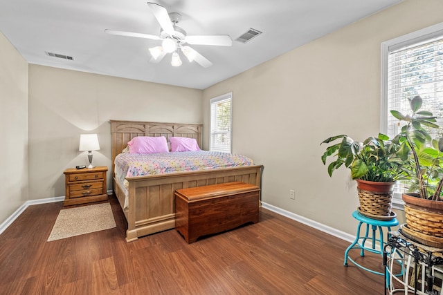 bedroom with wood finished floors, baseboards, and a ceiling fan