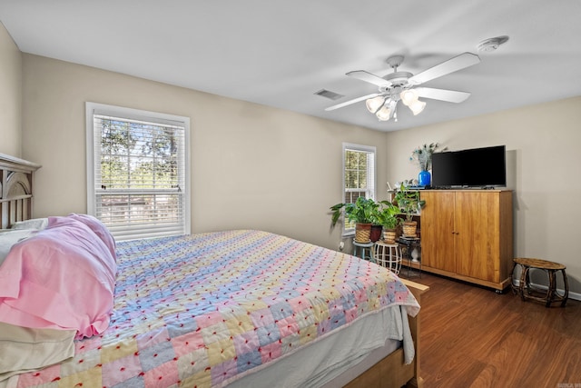 bedroom with dark wood-style flooring and a ceiling fan