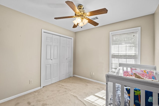 bedroom featuring carpet flooring, baseboards, a closet, and ceiling fan