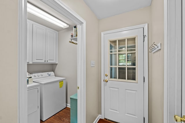 clothes washing area with washer and dryer, cabinet space, dark wood-style flooring, and baseboards