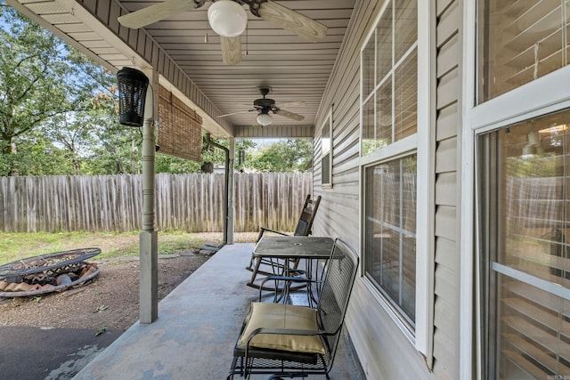 view of patio / terrace featuring a ceiling fan and an outdoor fire pit