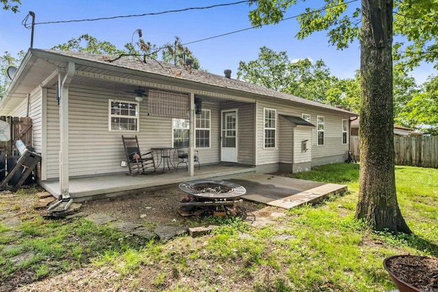 rear view of house with a patio area and an outdoor fire pit
