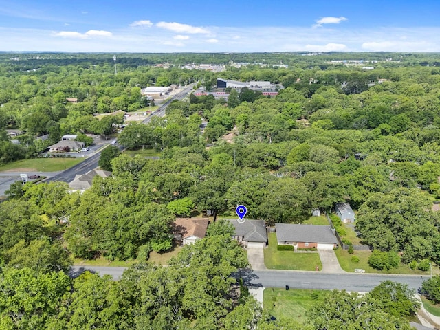 view of property location featuring a forest