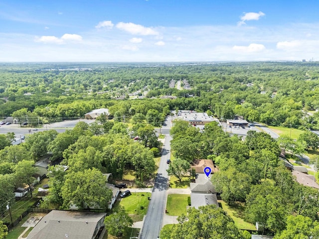aerial view of property's location featuring a forest