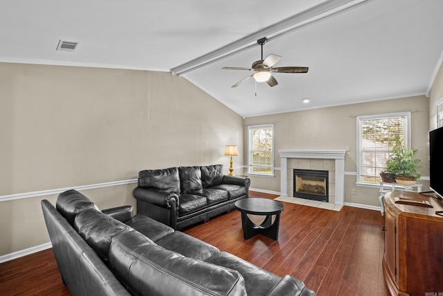 living area featuring wood finished floors, ceiling fan, plenty of natural light, and crown molding