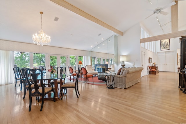 5000 Central Ave Unit 26-27, Hot Springs, AR 71913 - dining room featuring high vaulted ceiling, beamed ceiling, light wood-style floors, a chandelier, and a glass covered fireplace