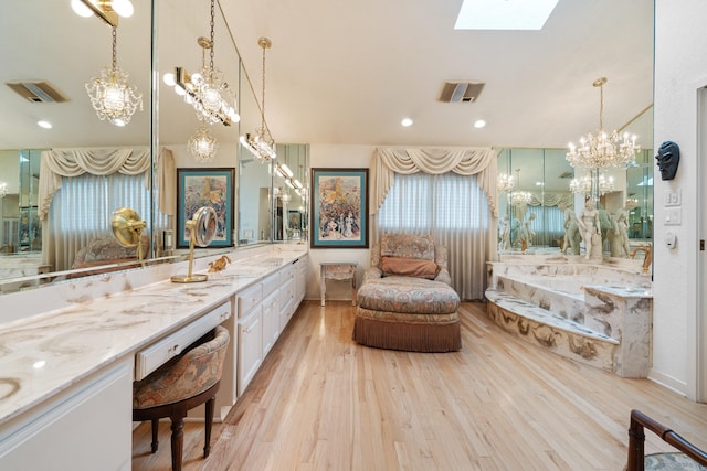 5000 Central Ave Unit 26-27, Hot Springs, AR 71913 - bathroom featuring a chandelier, wood finished floors, a skylight, vanity, and a garden tub
